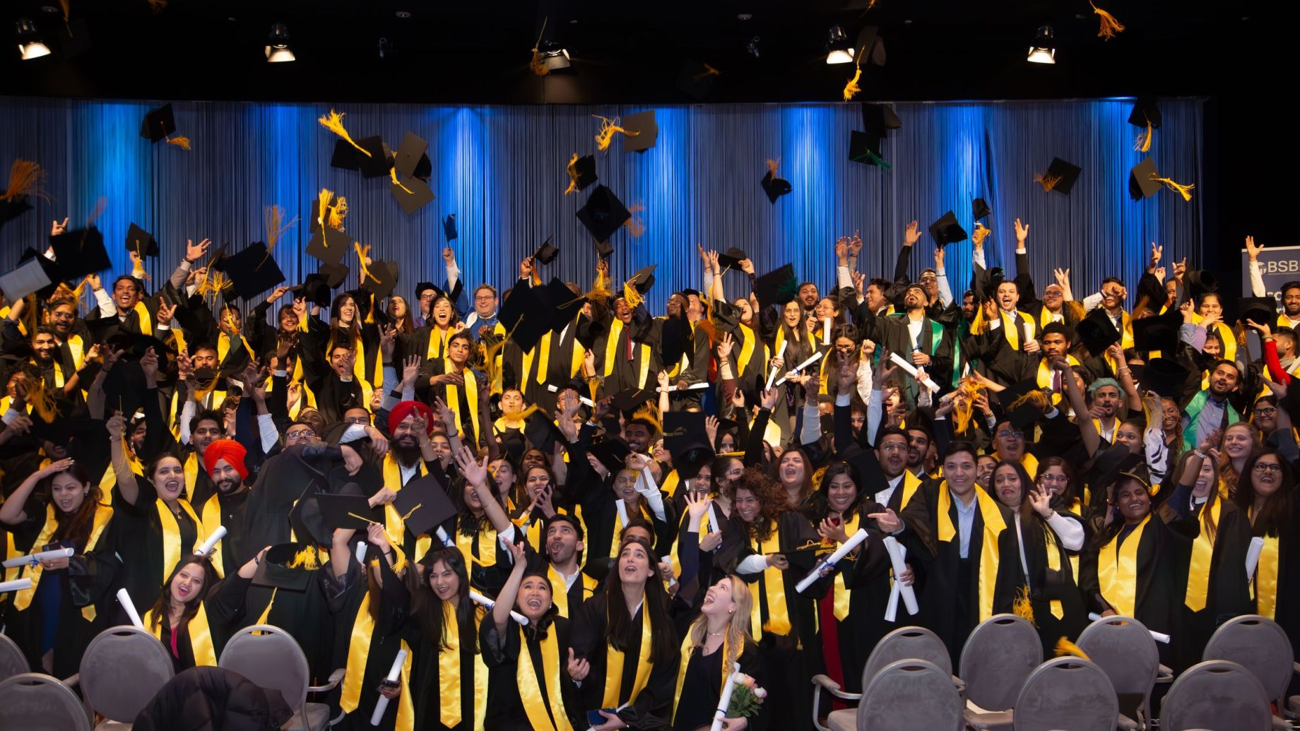 A graduating class celebrating together